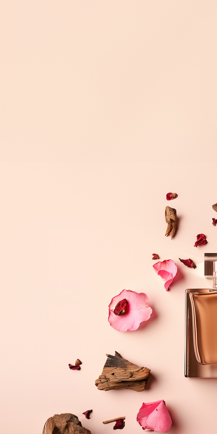 Perfume on pink background with oud wood and rose petals